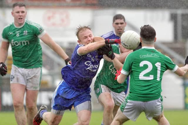 Claudy's Martin Donaghy gets an elbow from Kevin Sweeney of Newbridge during the Derry SFC at Owenbeg on Saturday. (Picture: Margaret McLaughlin)