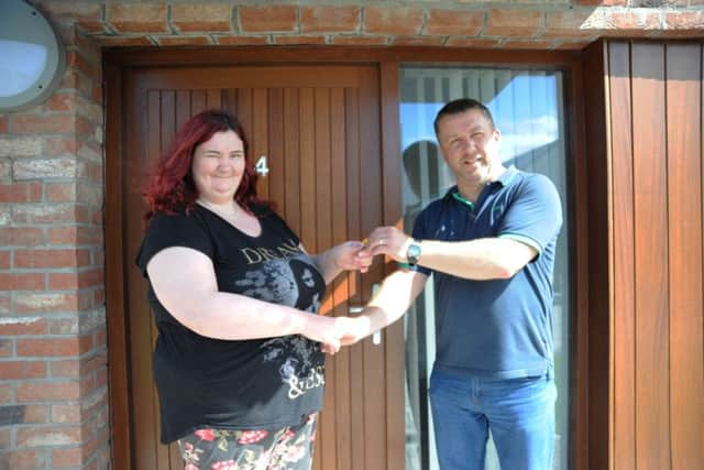 George Walker, Holly Lane Manager presenting Katty Devlin with the keys to her new home.