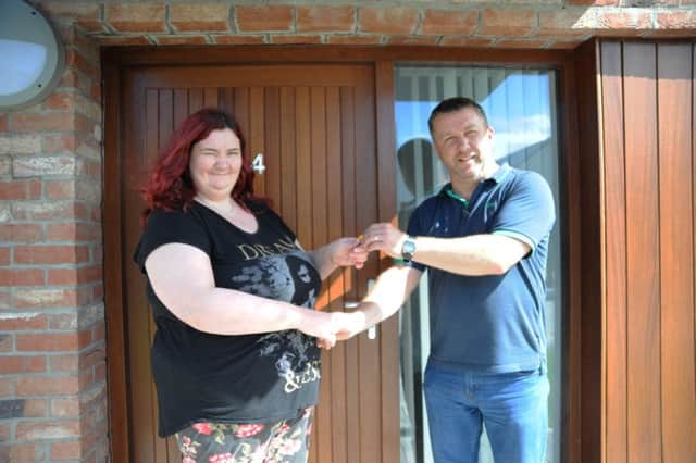 George Walker, Holly Lane Manager presenting Katty Devlin with the keys to her new home.