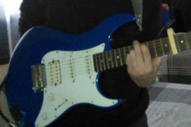 This blue electric Stratocaster guitar was stolen.