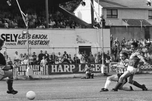 Derry City striker Jonathan Speak scores his side's second goal despite the close attention of Finn Harps' defender, Terry Leake, during a League Cup tie at Brandywell.