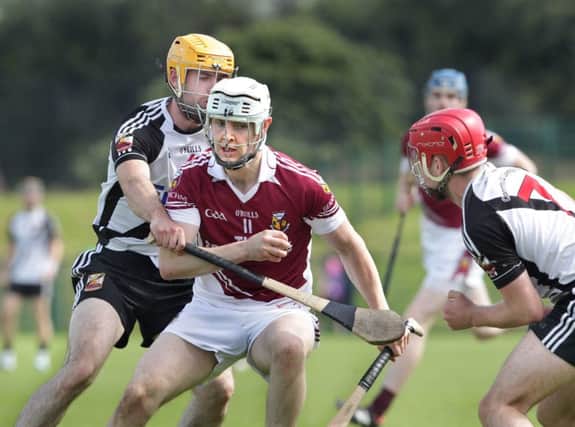 Kevin Lynch's Patrick Kelly and Ciaran O'Kane try to crowd out Banagher's Steafan McCloskey during Sunday's Derry Senior Hurling Championship semi-final on Sunday at Owenbeg. (Picture Margaret McLaughlin)