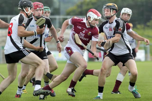 Kevin Lynch's Corey O'Reilly tries to halt the run of Banagher's Gabriel Farren during the Derry Senior Hurling Championship semi-final on Sunday at Owenbeg. (Picture Margaret McLaughlin)