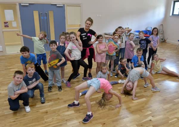 Children from Gaelscoil Ã‰adain MhÃ³ir Lecky Road pictured with dance tutor Laura Doherty from Flaunt Ur Step at the Gasyard Centre on Thursday afternoon as part of the Gaelscoil Summer Scheme. DER3416GS