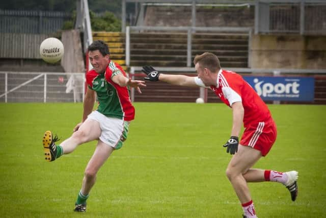 Slaughtmanus' Barry Lyons kicks a point during Saturday's game at Celtic Park against Drumsurn. DER3616MC018