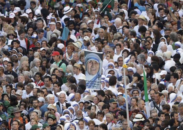 Faithful and pilgrims wait to enter in St. Peter's Square at the Vatican before a canonization ceremony, Sunday,. Thousands of pilgrims thronged to St. Peter's Square on Sunday for the canonization of Mother Teresa, the tiny nun who cared for the world's most unwanted and became the icon of a Catholic Church that goes to the peripheries to tend to lost, wounded souls. (AP Photo/Alessandra Tarantino)