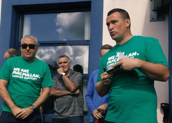 Neil Mullan from Limavady, with Ken Lowry, addresses those who participated in the charity football match.