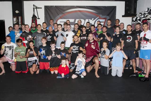 Nathan Corbett (front kneeling centre), 11-times World Champion Australian Heavyweight Kickboxer pictured at Strike Martial Arts Academy, Bay Road on Friday night last. He is pictured with coaches and club members. DER3616MC001