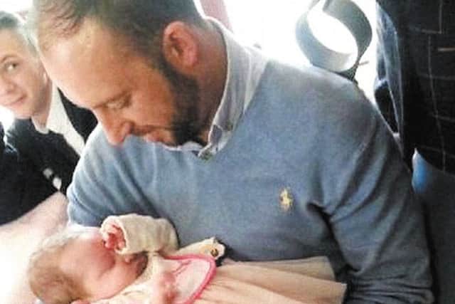 Buncrana hero Davitt Walsh holds baby Rioghnach-Ann. Mr. Walsh won the award for Outstanding Bravery at the Derry Journal People of the Year Awards 2016. Photo: Pacemaker.