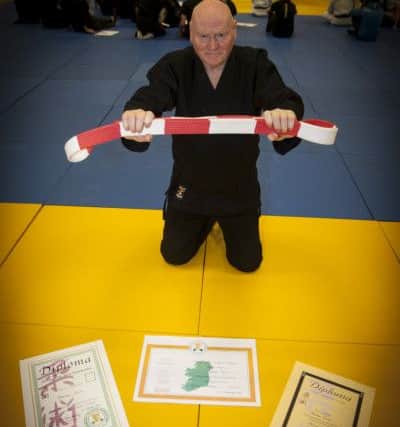 BLACK BELT!. . . . . .75 years-old Bernard Smith pictured with his Godan Grade Black Belt; Rokudan Black Belt Diploma and his Teacher's Diploma in Jiu Jitsu at the Foyle Arena on Tuesday night. Bernard is a member of the Ireland 32 Ju Jitsu International Club at the Arena. INLS3416MC003 (Photo: jim McCafferty)