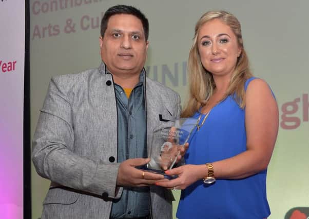 Dr Mukesh Chung receiving the award for Contribution to Arts and Culture from the Derry Journals  Louise Strain at the Derry Journal People of the Year Awards in the Everglades Hotel Derry on Thursday evening last. DER3616GS047