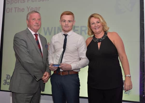 Sports Person of the Year Bret McGinty receives the award from Deric Henderson representing associate sponsor A McLean Bookmakers and Andrena OPrey from Johnston Press at the Derry Journal People of the Year Awards in the Everglades Hotel Derry on Thursday evening last. DER3616GS054