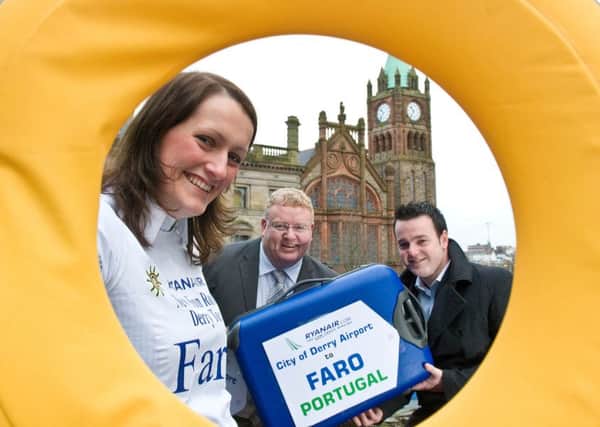 Happier times. Laura McCormack from Ryanair preparing to jet off to Faro in Portugal after the airline announced a second international route for City of Derry Airport to add to the already popular Alicante flight in 2009. Helping to pack her bags were Damien Tierney, City of Derry Airport manager and the then, Councillor Colm Eastwood, Chairman of the airport committee. Picture Martin McKeown. Inpresspics.com. 16.12.09