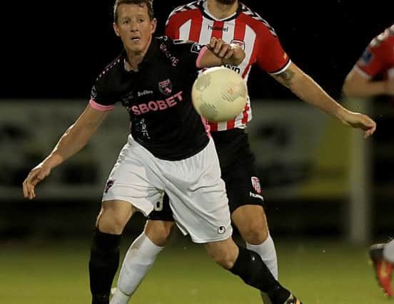 Derry City defender  Max Karner, who played his first 90 minutes for the club in Wexford, forces 
Aidan Keenan away from goal.