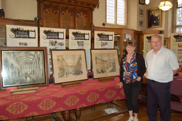 Moira McIntosh and Ivor Doherty view the paintings by Alexander McFarland at St Columbs Cathedral