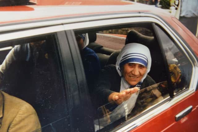 Saint Teresa of Calcutta, then known as Mother Teresa, reaches out to shake Breige's hand.