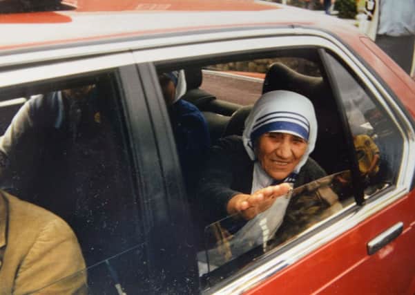 Saint Teresa of Calcutta, then known as Mother Teresa, reaches out to shake Breige's hand.
