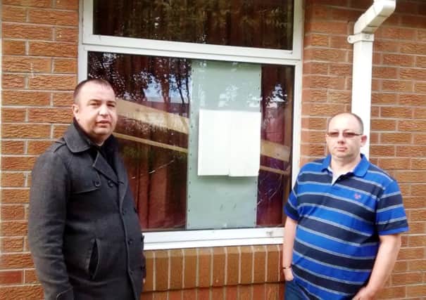 Councillor Brian Tierney (on left) and Keith Wright, Family History Centre Director at Derrys Mormon Church,  pictured beside one of the broken windows.