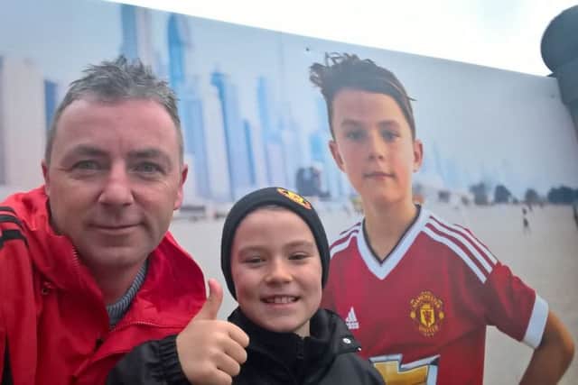Ryan and his dad, Ronan, pictured outside Old Trafford this week on their unforgettable six day trip.