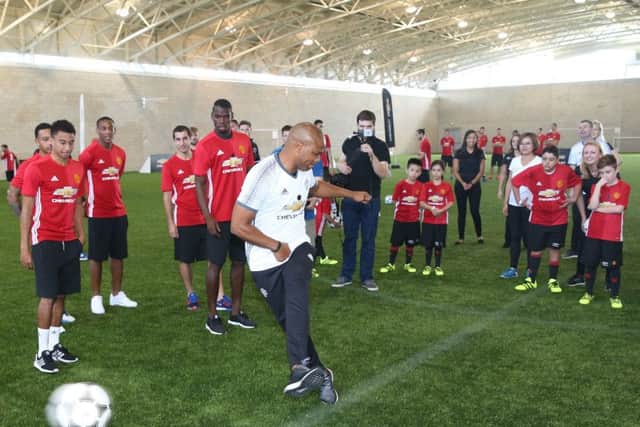 United legend, Quinton Fortune puts away a penalty as Ryan watches on at a training session at Carrington today.