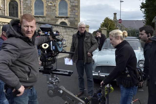 Director Tom Collins (centre) on the set of his new feature film Penance (AithrÃ­) during filming at St Columbas Church Long Tower yesterday.  DER4016GS006