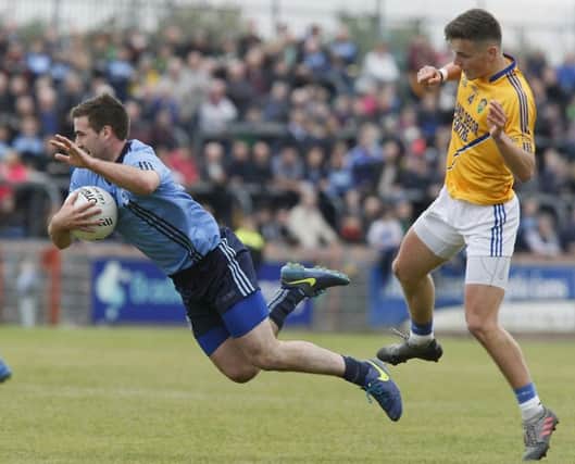 Killyclogher's Emmet McFadden is sent flying from this challenge by Coalisland's Michael McKernan during Sunday's Senior Championship final.