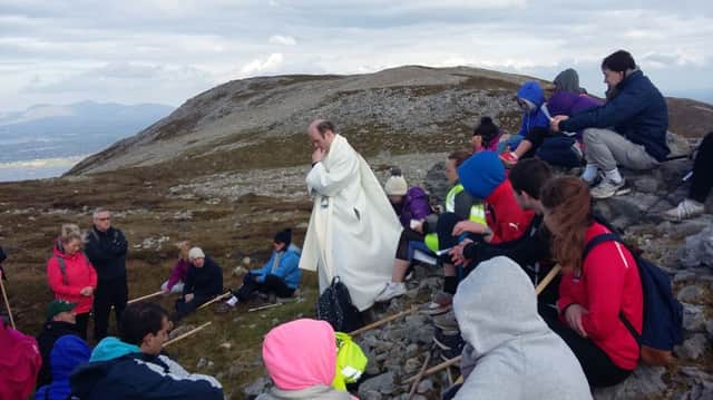 Father Christopher McDermott says Mass on Croagh Patrick.