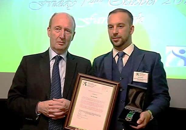 Davitt Walsh receives his bravery award from Irish Transport Minister Shane Ross.