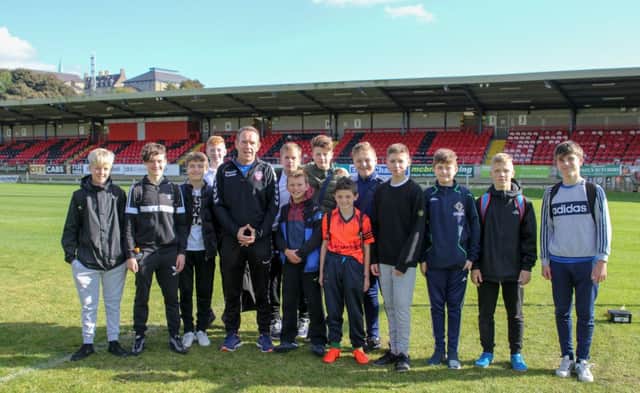 Derry City manager, Kenny Shiels pictured with the Nendrum College U14 football team during a recent impromptu visit to Brandywell Stadium.