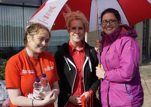 Danielle Coyle from Fujitsu with Rhonda Murphy and Annette Keenan from the Waterside Action for Children Branch, Derry. Staff from Fujitsu helped raise Â£8,000 for the charity during a recent 5k at Timber Quay in Derry.