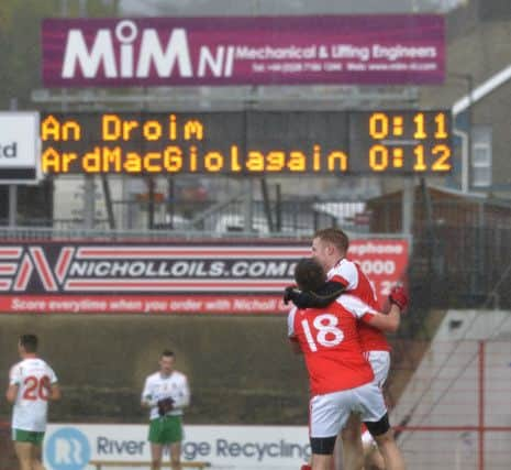 Magilliagns Barry Mullan (18) and captain Michael McLaughlin celebrate at the final whistle at Sundays  Junior Football Championship Final in Celtic Park. DER4216GS009