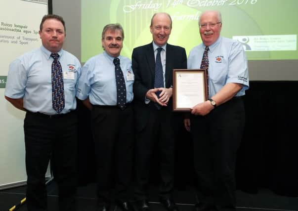 Minister for Transport, Tourism & Sport Shane Ross, T.D. presents the award to Liugh Swilly RNLI  Lifeboat Operations Manager John McCarter, Coxswain Mark Barnett and Deputy Launching Authority Eunan McConnell.