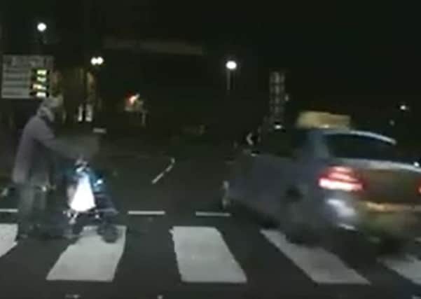 The moment a taxi driver almost collides with a pedestrian at a zebra crossing in Derry.