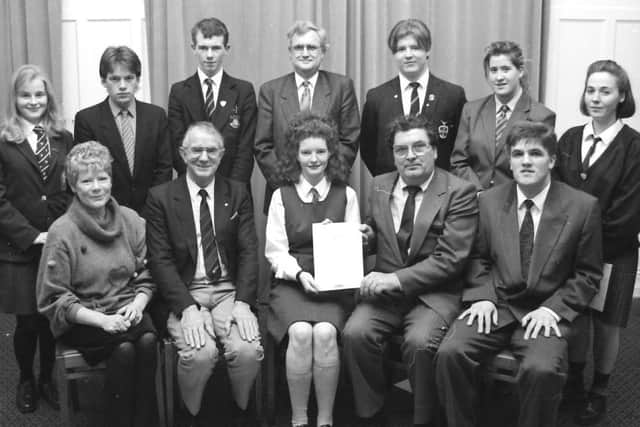 John Hume presents the Rotary Youth Leadership 91/92 Award to Aoife Reagan, of Thornhill College. Included, at front, are Phil Bredin, Inner Wheel, Frank Laurence, president, Derry Rotary Club, and Patrick O'Donnell, Standard Life, sponsors. At back are other certificate recipients in the city final. From left Lesley Craig (Foyle College), David Forbes (Clondermot High School), Andrew Watson (St Brecan's High School), Derek Lee (youth leadership convenor), Stephen McCauley (St Columb's College), Leanne Bullock (St Mary's Secondary School), and Clare McBride (St Cecilia's Secondary School).