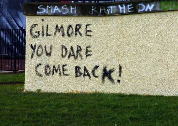 Graffiti warning Raymond Gilmore not to return home.