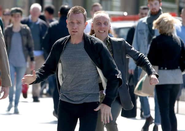 Actors Ewan McGregor (front) and Ewan Bremner (behind) running through the streets of Edinburgh where scenes for the new Trainspotting 2 is being filmed. PRESS ASSOCIATION Photo. Picture date: Wednesday July 13, 2016. Photo credit should read: Jane Barlow/PA Wire