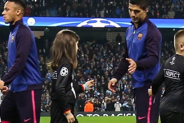 Mastercard mascot Cara McAteer about to touch hands with Luis Suarez  ahead of the UEFA Champions League match between Manchester City and FC Barcelona at the Etihad Stadium on November 1st, 2016 in Manchester.  Photo by Barrington Coombs/Getty Images for MasterCard