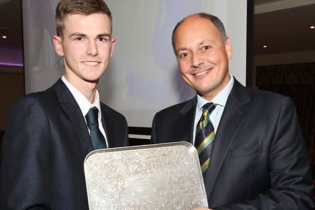 North West Cricket's Young Player of the Year, Graham Kennedy, receives his award from Cricket Ireland CEO, Mr Warren Deutrom in the White Horse Hotel.