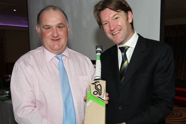 CricketEurope Points Player of the Year award winner, Junior McBrine (left), receives a Kookaburra bat from NW Chairman, Andrew Fleming, in the White Horse hotel.
