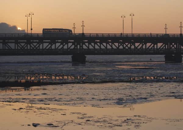 The setting sun highlights the ice on the River Foyle at Craigavon Bridge in 2011. LS02-108KM10