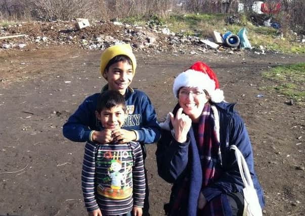 Ruth pictured with  children from Romania when she distributed shoeboxes following last year's appeal.