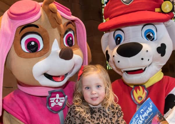Three years old Maisie Flood reads Derry City and Strabane District Council's, "Light Up Your Christmas" guide  with Skye and Marshall from Paw Patrol. Picture Martin McKeown. Inpresspics.com.
