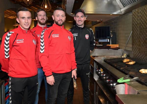 Derry City footballers Aaron McEneff, Ryan McBride, Rory Patterson and Gerard Doherty helped with cooking and serving food in a fundraising event for Foyle Search and Rescue at Nandos restaurant on Wednesday evening last. DER4616GS014