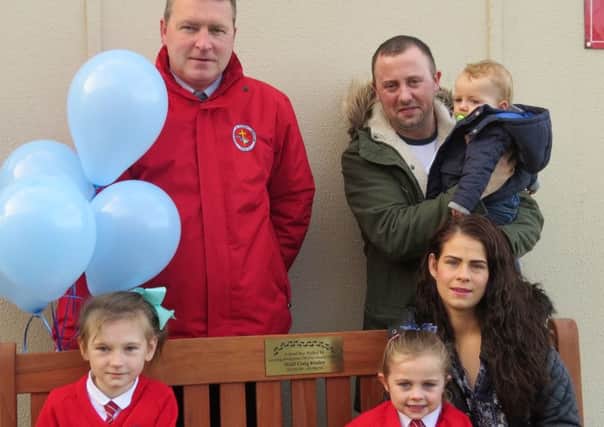 At back, far left is Saint Canice PS, Dungiven Principal, Ciaran Loane with Damien and Caroline Kealey, their children Patrick and Nadine. Also pictured (front, far left) is St. Canice PS pupil Kathryn. They're pictured at the unveiling of a special bench at St. Canice PS where Damian and Caroline's son, Niall,  attended nursery and school. The bench is in memory of Niall, who sadly passed away from illness in 2014. 
Turn to page 3.