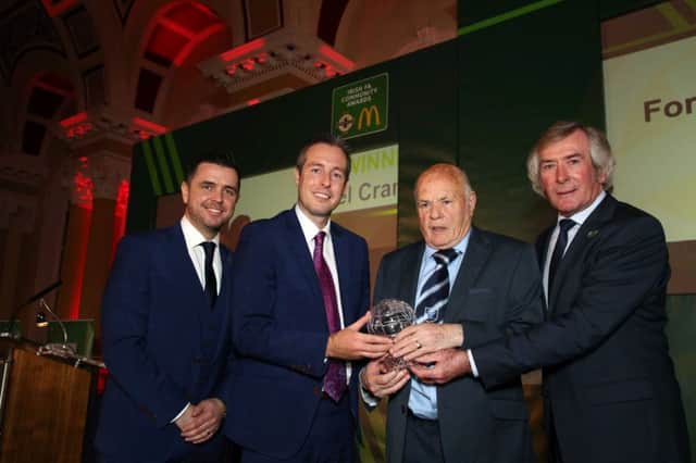 Oxford United's Noel Crampsey is presented with his IFA's People's award by McDonalds Head of Northern Ireland Football Pat Jennings and Minister for Communities Paul Givan. 
 Picture by Darren Kidd/Press Eye.
