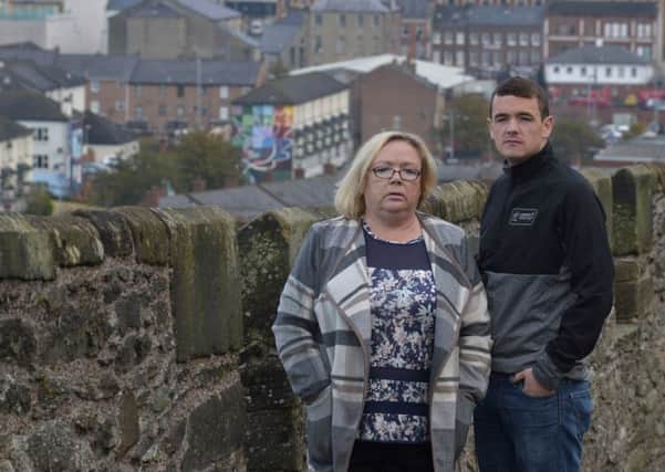 Helen Deery and her son, Sean MacHugh pictured on the city's walls close to the spot where a British soldier fired the bullet that killed 15-year-old Manus Derry in 1972. DER4216GS035