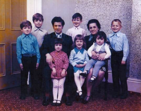 John Toland pictured with his wife, Marie, and seven children.