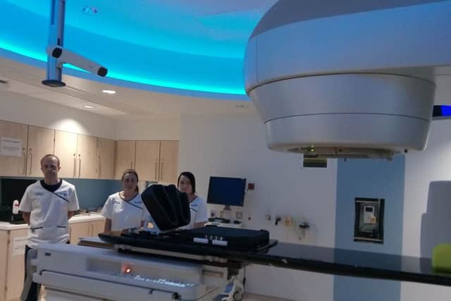 Staff beside one of the three Â£1.5m radiotherapy treatment machines  at the new North West Cancer Centre.