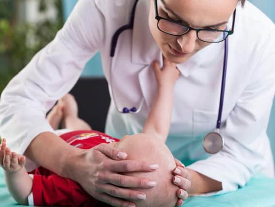 A doctor checking a child
