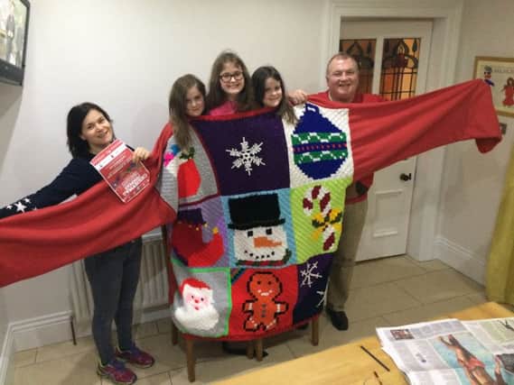 Aoibhean and Kevin Casey and their daughters Niamh (9), Clara (8) and Sarah (11) trying out the giant Christmas jumper.